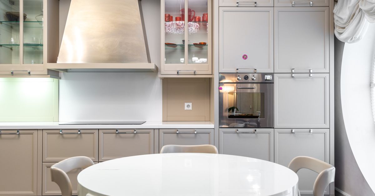 Contemporary kitchen with sleek cabinets and a round dining table.